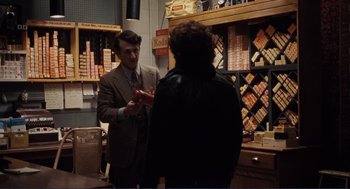 Movie still from “Milk” (2008), directed by Gus Van Sant – A man is talking to a woman in a store; Medium shot, Over the shoulder angle