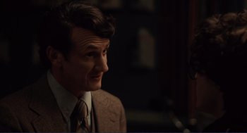 Movie still from “Milk” (2008), directed by Gus Van Sant – A person wearing a suit and tie; Close Up shot, Over the shoulder angle