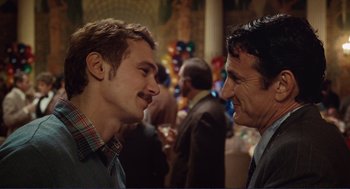 Movie still from “Milk” (2008), directed by Gus Van Sant – Two men talking to each other at a party; Close Up shot, Over the shoulder angle