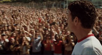 Movie still from “Milk” (2008), directed by Gus Van Sant – A crowd of people standing in front of an audience; Medium shot, High angle