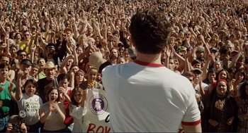 Movie still from “Milk” (2008), directed by Gus Van Sant – A crowd of people in front of a man in a white shirt; Wide shot, High angle