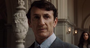 Movie still from “Milk” (2008), directed by Gus Van Sant – A person wearing a suit and tie; Close Up shot, Low angle