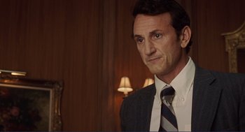 Movie still from “Milk” (2008), directed by Gus Van Sant – A person wearing a suit and tie; Close Up shot, Over the shoulder angle