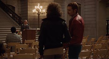 Movie still from “Milk” (2008), directed by Gus Van Sant – A man and a woman standing next to each other in a room; Wide shot, Over the shoulder angle