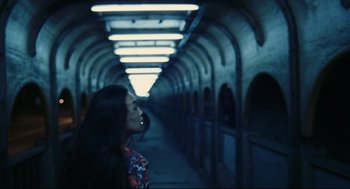 Movie still from “Millennium Mambo” (2001), directed by Hsiao-Hsien Hou – A woman is standing in a dark tunnel; Medium shot, High angle