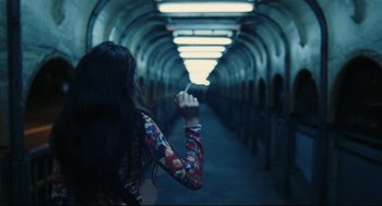Movie still from “Millennium Mambo” (2001), directed by Hsiao-Hsien Hou – A woman is walking down a long hallway; Medium shot, Over the shoulder angle