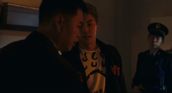 Movie still from “Millennium Mambo” (2001), directed by Hsiao-Hsien Hou – Two men standing next to each other in the dark; Medium shot, Over the shoulder angle