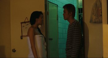 Movie still from “Millennium Mambo” (2001), directed by Hsiao-Hsien Hou – A man and a woman standing next to each other; Medium shot, Low angle