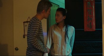 Movie still from “Millennium Mambo” (2001), directed by Hsiao-Hsien Hou – A man and a woman holding each other's hands; Medium shot, Low angle