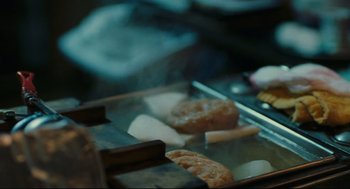 Movie still from “Millennium Mambo” (2001), directed by Hsiao-Hsien Hou – Some food being cooked on a griddle; Extreme Close Up shot, High angle