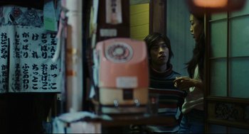 Movie still from “Millennium Mambo” (2001), directed by Hsiao-Hsien Hou – A man in striped shirt looking into a mirror; Medium shot, Low angle