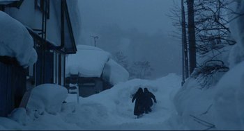 Movie still from “Millennium Mambo” (2001), directed by Hsiao-Hsien Hou – Two people are walking through the deep snow; Extreme Wide shot, High angle