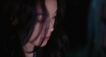 Movie still from “Millennium Mambo” (2001), directed by Hsiao-Hsien Hou – A person with long black hair; Close Up shot, Over the shoulder angle