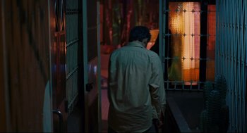 Movie still from “Millennium Mambo” (2001), directed by Hsiao-Hsien Hou – A man walking down a hallway at night; Medium shot, Over the shoulder angle