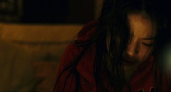 Movie still from “Millennium Mambo” (2001), directed by Hsiao-Hsien Hou – A person with long black hair; Extreme Close Up shot, High angle