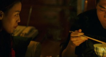 Movie still from “Millennium Mambo” (2001), directed by Hsiao-Hsien Hou – A person holding a cigarette in their hand; Close Up shot, Low angle