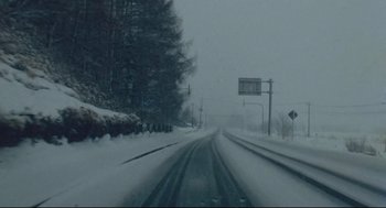 Movie still from “Millennium Mambo” (2001), directed by Hsiao-Hsien Hou – A snowy road with trees in the background; Extreme Wide shot, Low angle