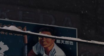 Movie still from “Millennium Mambo” (2001), directed by Hsiao-Hsien Hou – A person's face on a poster; Extreme Close Up shot, Low angle