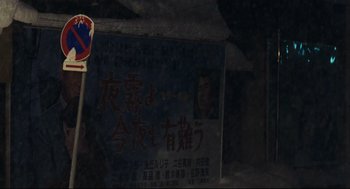 Movie still from “Millennium Mambo” (2001), directed by Hsiao-Hsien Hou – An asian sign in the dark of night; Extreme Close Up shot, High angle