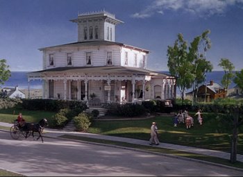 Movie still from “Million Dollar Mermaid” (1952), directed by Mervyn LeRoy – People walking in front of an old white house; Extreme Wide shot, High angle