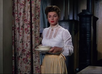 Movie still from “Million Dollar Mermaid” (1952), directed by Mervyn LeRoy – A woman holding a plate in her hands; Medium shot, Low angle