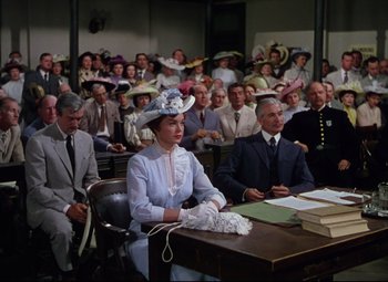 Movie still from “Million Dollar Mermaid” (1952), directed by Mervyn LeRoy – A group of people sitting at a table in front of a crowd; Medium shot, High angle