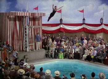 Movie still from “Million Dollar Mermaid” (1952), directed by Mervyn LeRoy – An acrobat performs a trick in front of an audience; Wide shot, High angle