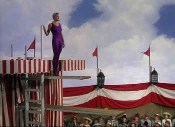 Movie still from “Million Dollar Mermaid” (1952), directed by Mervyn LeRoy – A woman standing on top of a platform in front of a crowd of people; Wide shot, Low angle