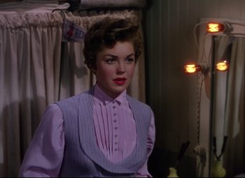 Movie still from “Million Dollar Mermaid” (1952), directed by Mervyn LeRoy – A woman in a purple shirt and a purple vest; Medium shot, Over the shoulder angle