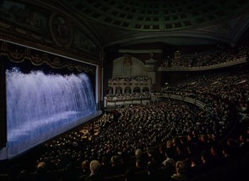 Movie still from “Million Dollar Mermaid” (1952), directed by Mervyn LeRoy – An audience is sitting in front of a stage with a waterfall; Extreme Wide shot, High angle