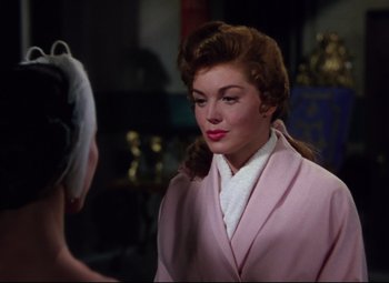 Movie still from “Million Dollar Mermaid” (1952), directed by Mervyn LeRoy – A woman in a pink coat is talking to another woman in a pink coat; Close Up shot, Over the shoulder angle