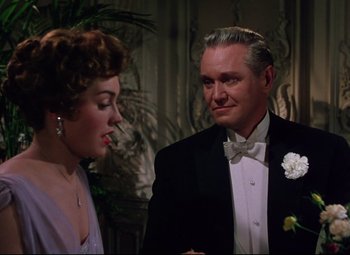 Movie still from “Million Dollar Mermaid” (1952), directed by Mervyn LeRoy – A man and a woman in formal wear looking at each other; Medium shot, Over the shoulder angle