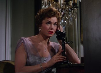 Movie still from “Million Dollar Mermaid” (1952), directed by Mervyn LeRoy – A woman holding a phone up to her face; Close Up shot, High angle