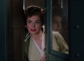 Movie still from “Million Dollar Mermaid” (1952), directed by Mervyn LeRoy – A woman with red lipstick looking into a mirror; Medium shot, Over the shoulder angle