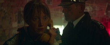 Movie still from “Mindhorn” (2016), directed by Sean Foley – A man and a woman on the phone in a dark room; Close Up shot, Low angle