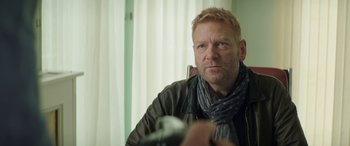 Movie still from “Mindhorn” (2016), directed by Sean Foley – A person with a camera wearing a scarf; Close Up shot, Over the shoulder angle