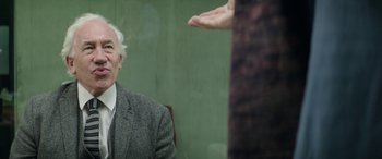 Movie still from “Mindhorn” (2016), directed by Sean Foley – An older man sitting in a chair in front of an older woman; Close Up shot, Over the shoulder angle