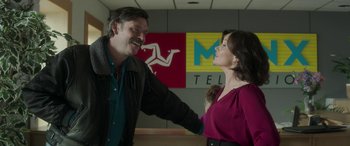 Movie still from “Mindhorn” (2016), directed by Sean Foley – A man and a woman standing next to each other; Medium shot, Over the shoulder angle