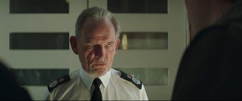 Movie still from “Mindhorn” (2016), directed by Sean Foley – An older man wearing a white shirt and a tie; Close Up shot, Low angle