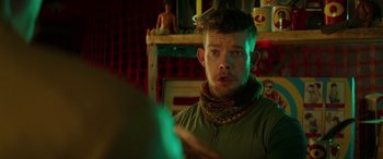 Movie still from “Mindhorn” (2016), directed by Sean Foley – A man with a bandage around his neck looking at the camera; Close Up shot, Over the shoulder angle