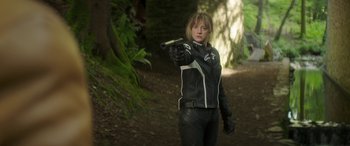 Movie still from “Mindhorn” (2016), directed by Sean Foley – A woman in a black leather jacket holding a gun; Medium shot, Low angle