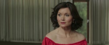 Movie still from “Mindhorn” (2016), directed by Sean Foley – A person wearing a red dress; Close Up shot, Over the shoulder angle