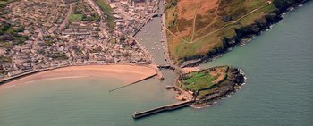 Movie still from “Mindhorn” (2016), directed by Sean Foley – An aerial view of a small town and a harbor; Extreme Wide shot, High angle
