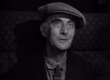 Movie still from “Ministry of Fear” (1944), directed by Fritz Lang – An older man wearing a hat and a jacket; Close Up shot, Low angle
