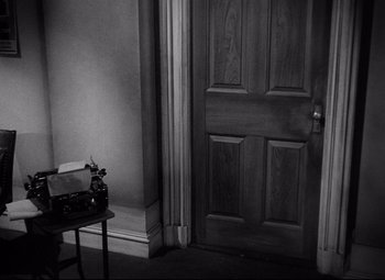 Movie still from “Ministry of Fear” (1944), directed by Fritz Lang – A black - and - white photo of an open door; Medium shot, High angle