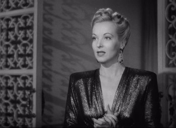 Movie still from “Ministry of Fear” (1944), directed by Fritz Lang – A black - and - white photo of a woman in a dress; Close Up shot, Over the shoulder angle