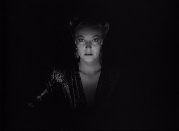 Movie still from “Ministry of Fear” (1944), directed by Fritz Lang – A black and white photo of a woman in the dark; Close Up shot, Low angle