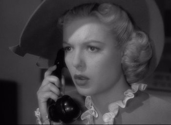 Movie still from “Ministry of Fear” (1944), directed by Fritz Lang – A black and white photo of a woman talking on a phone; Close Up shot, High angle