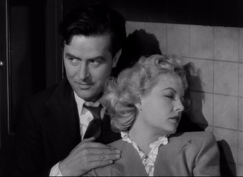 Movie still from “Ministry of Fear” (1944), directed by Fritz Lang – A man and a woman are posing for a picture; Close Up shot, High angle