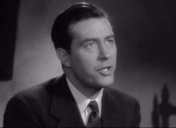 Movie still from “Ministry of Fear” (1944), directed by Fritz Lang – A man in a suit and tie is looking to his left; Close Up shot, Low angle